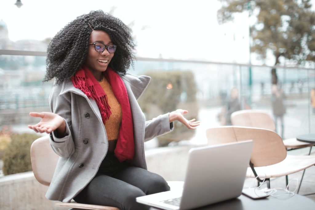 woman having fun while staying connected when working remotely on laptop
