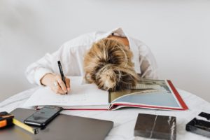 unmotivated girl laying head down on book
